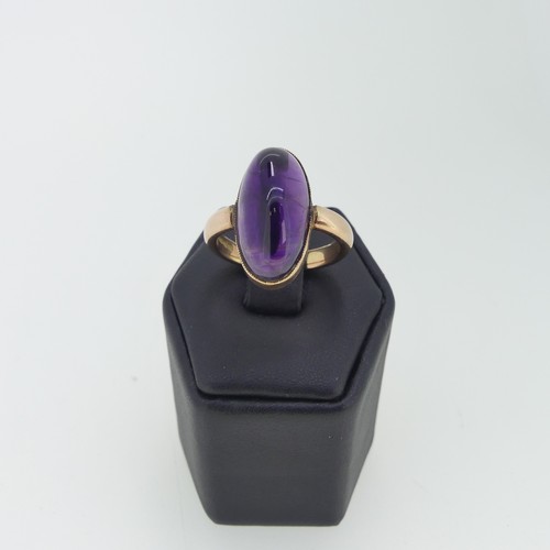 110 - An oval cabochon amethyst Ring, 2cm long, mounted in 9ct rose gold, Size M, 7.2g.