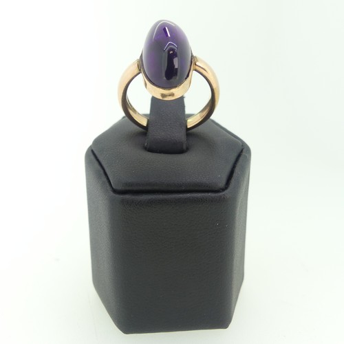 110 - An oval cabochon amethyst Ring, 2cm long, mounted in 9ct rose gold, Size M, 7.2g.