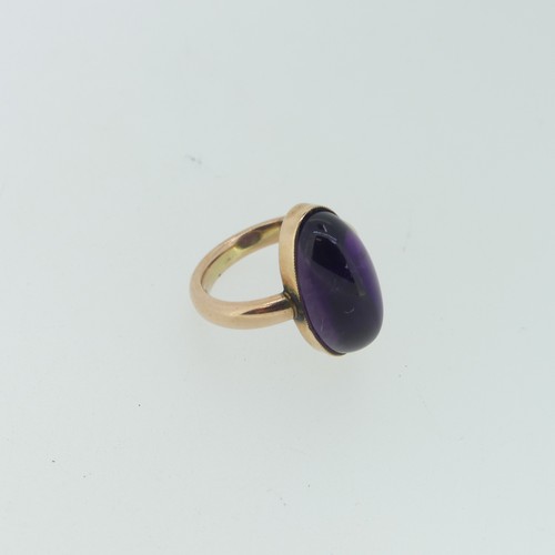 110 - An oval cabochon amethyst Ring, 2cm long, mounted in 9ct rose gold, Size M, 7.2g.