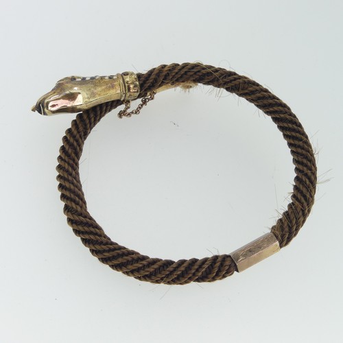 180 - A 19thC snake memorial Bangle, formed of woven hair with enamelled snake head and tail finials, the ... 