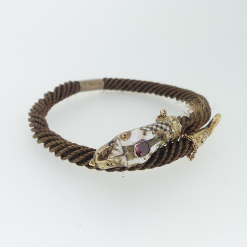 180 - A 19thC snake memorial Bangle, formed of woven hair with enamelled snake head and tail finials, the ... 