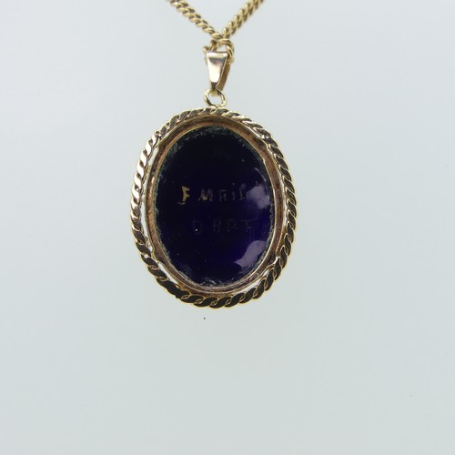 153 - An 18ct gold mounted enamel Pendant, with rope border, 25mm long exc. suspension loop, on an 18ct go... 