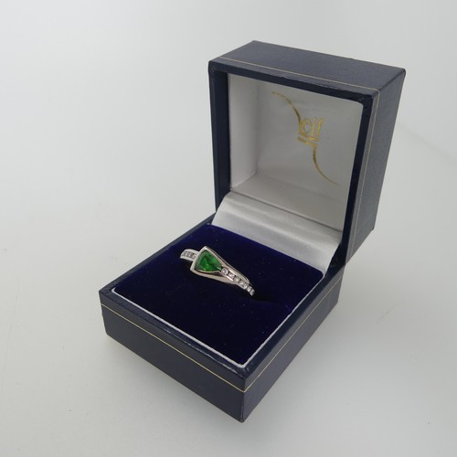 115 - A modernist tsavorite and diamond Ring, the trilliant cut stone approx 4.6mm long, collet set with s... 