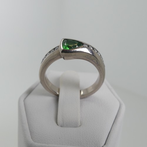 115 - A modernist tsavorite and diamond Ring, the trilliant cut stone approx 4.6mm long, collet set with s... 