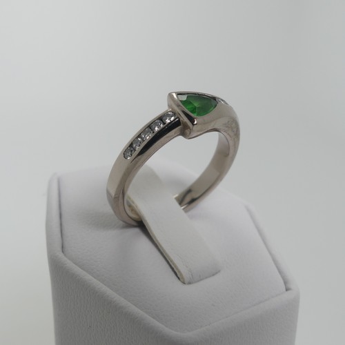 115 - A modernist tsavorite and diamond Ring, the trilliant cut stone approx 4.6mm long, collet set with s... 