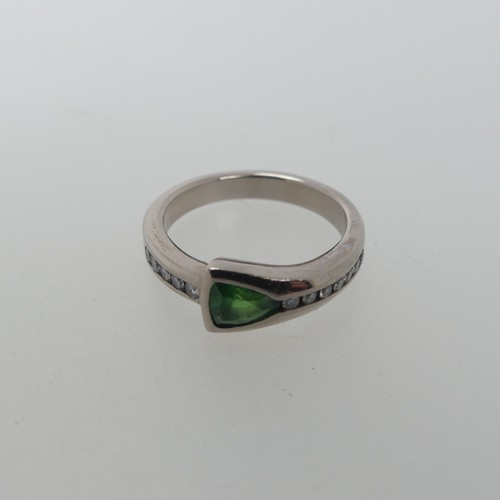 115 - A modernist tsavorite and diamond Ring, the trilliant cut stone approx 4.6mm long, collet set with s... 