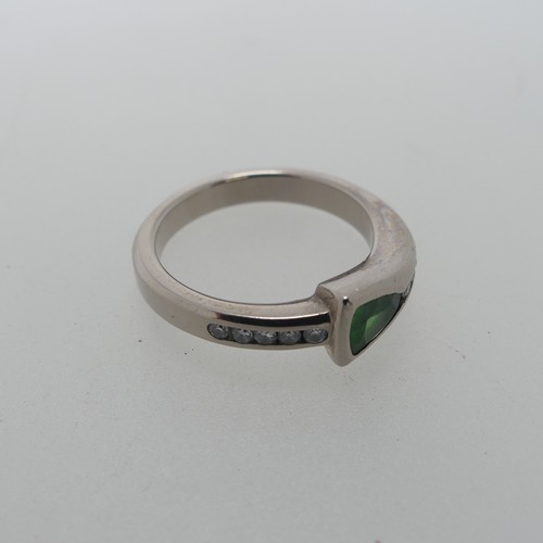 115 - A modernist tsavorite and diamond Ring, the trilliant cut stone approx 4.6mm long, collet set with s... 