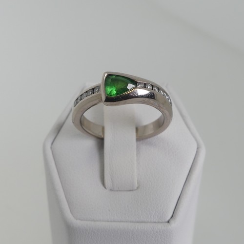 115 - A modernist tsavorite and diamond Ring, the trilliant cut stone approx 4.6mm long, collet set with s... 