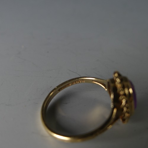 234 - A 9ct yellow gold and amethyst Ring, the oval facetted stone 9.5mm long, in a ropetwist mount, Size ... 