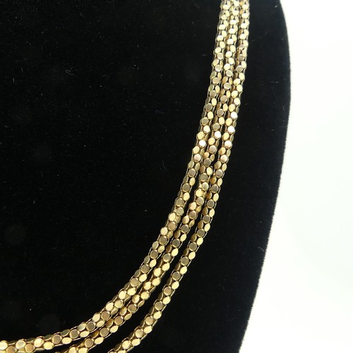 159 - A 9ct gold triple row Necklace, with bolt ring clasp, 54cm long, 15.6g.