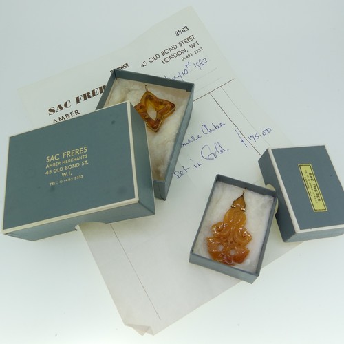 237 - A gold mounted carved amber 'Star' Pendant, 4cm wide, unmarked, tests as 9ct, in accompanying box an... 