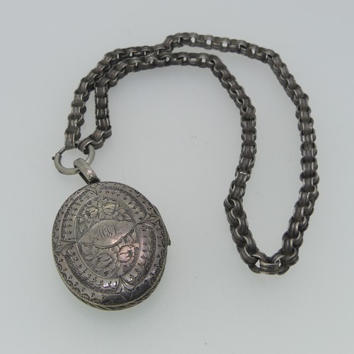 244 - A Victorian aesthetic period Locket and Chain, the oval hinged locket with foliate decoration, initi... 