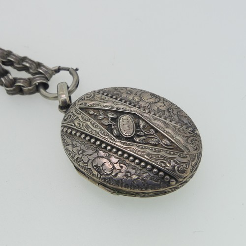 244 - A Victorian aesthetic period Locket and Chain, the oval hinged locket with foliate decoration, initi... 