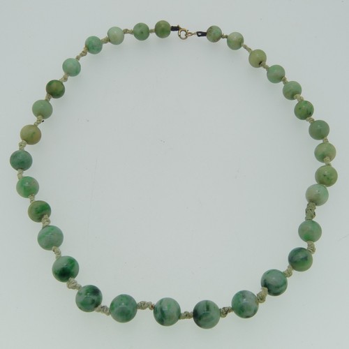 161 - A jade bead Necklace, formed of thirty one circular jades, each approx. 9mm diameter, individually k... 