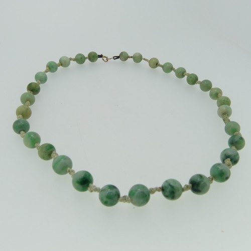 161 - A jade bead Necklace, formed of thirty one circular jades, each approx. 9mm diameter, individually k... 