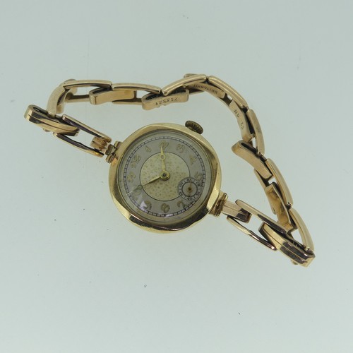 287 - A 9ct gold lady's Wristwatch, with Swiss 16-jewels movement, 25mm case diameter, on an expanding 9ct... 