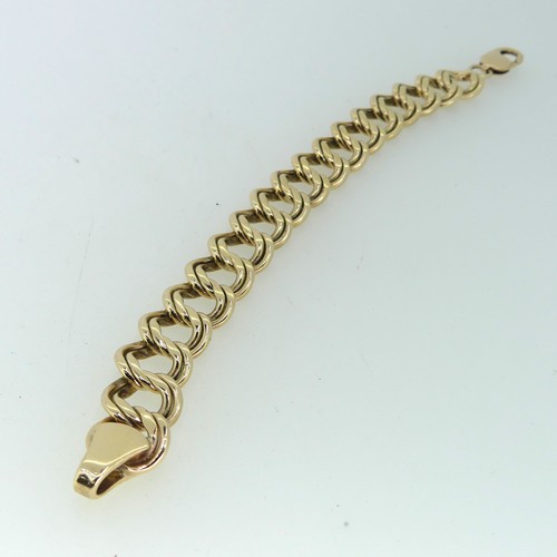 183 - A 9ct gold double circular link Bracelet, 15mm wide, 19cm long, and with one spare link removed, tot... 