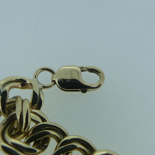 183 - A 9ct gold double circular link Bracelet, 15mm wide, 19cm long, and with one spare link removed, tot... 