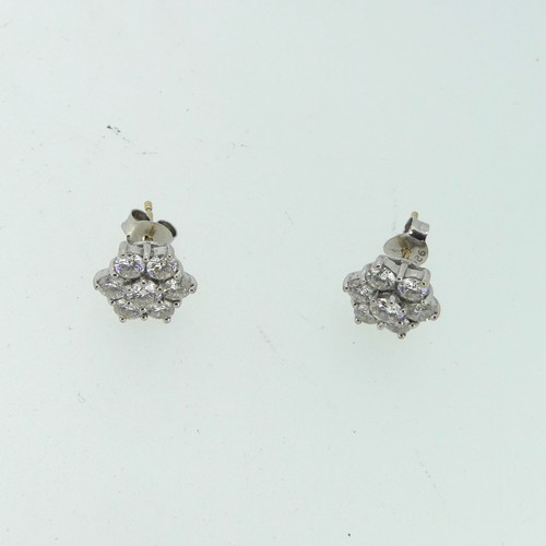 206 - A pair of diamond flowerhead cluster Earrings, the central circular diamond approx 0.17ct, claw set ... 