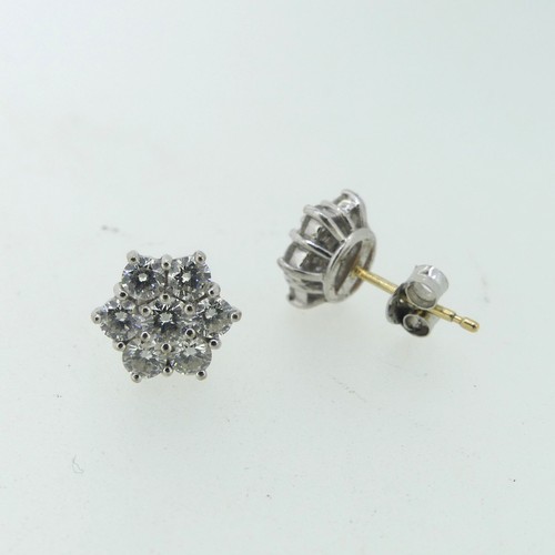 206 - A pair of diamond flowerhead cluster Earrings, the central circular diamond approx 0.17ct, claw set ... 