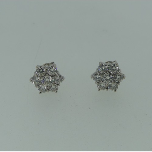 206 - A pair of diamond flowerhead cluster Earrings, the central circular diamond approx 0.17ct, claw set ... 