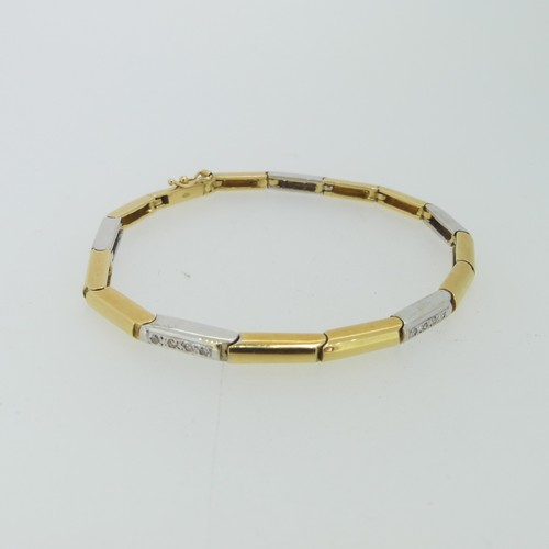 184 - An 18ct two colour gold flexible line Bracelet, formed of hinged rectangular yellow and white gold l... 