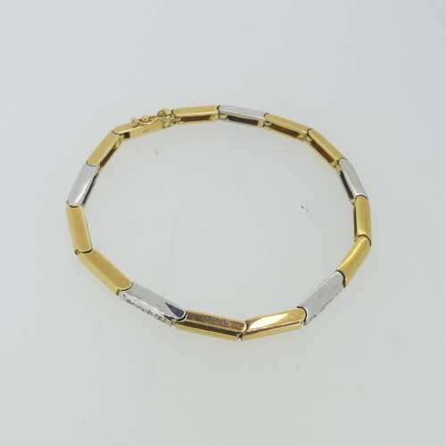 184 - An 18ct two colour gold flexible line Bracelet, formed of hinged rectangular yellow and white gold l... 