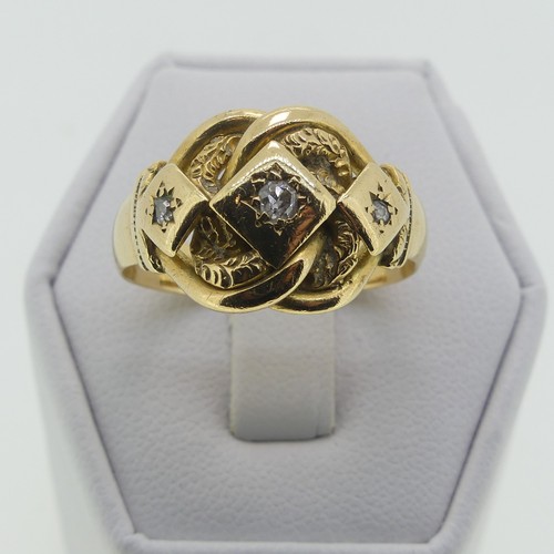 123 - An 18ct yellow gold Ring, the scrolling knot front gypsy set three diamond points, hallmarked Cheste... 