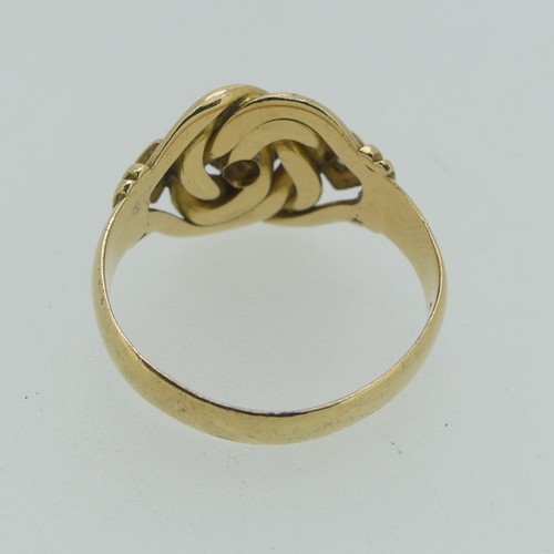 123 - An 18ct yellow gold Ring, the scrolling knot front gypsy set three diamond points, hallmarked Cheste... 