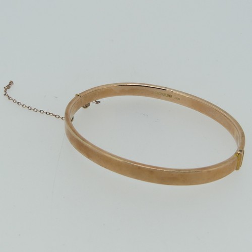 186 - A plain 9ct rose gold hollow hinged Bangle, 6.2g.