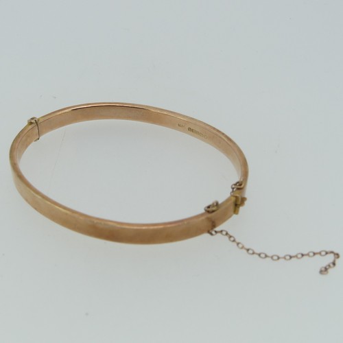 186 - A plain 9ct rose gold hollow hinged Bangle, 6.2g.