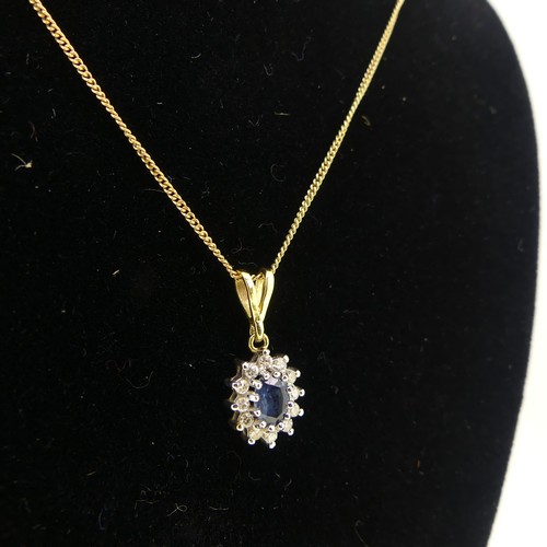 171 - A small sapphire and diamond cluster Pendant, the oval facetted pale sapphire approx 5.5mm long surr... 