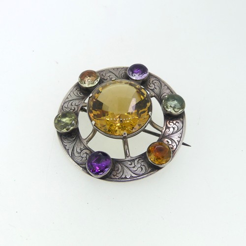 210 - An attractive Scottish circular silver Brooch, the central facetted citrine 23mm diameter, set above... 