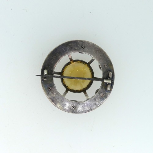 210 - An attractive Scottish circular silver Brooch, the central facetted citrine 23mm diameter, set above... 