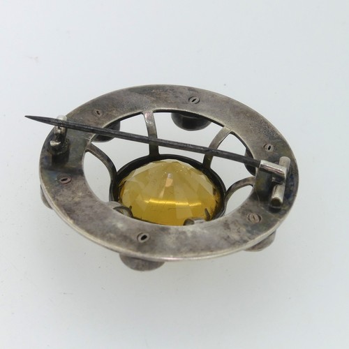 210 - An attractive Scottish circular silver Brooch, the central facetted citrine 23mm diameter, set above... 