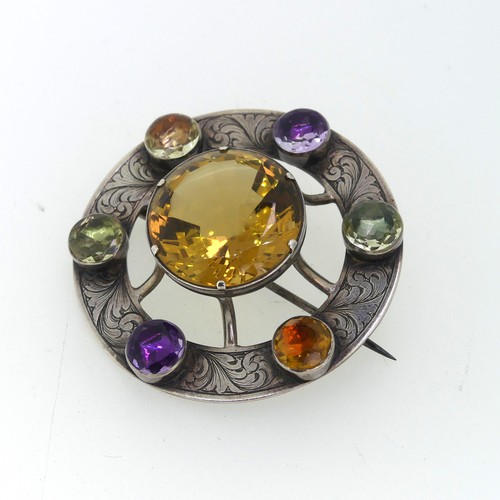 210 - An attractive Scottish circular silver Brooch, the central facetted citrine 23mm diameter, set above... 