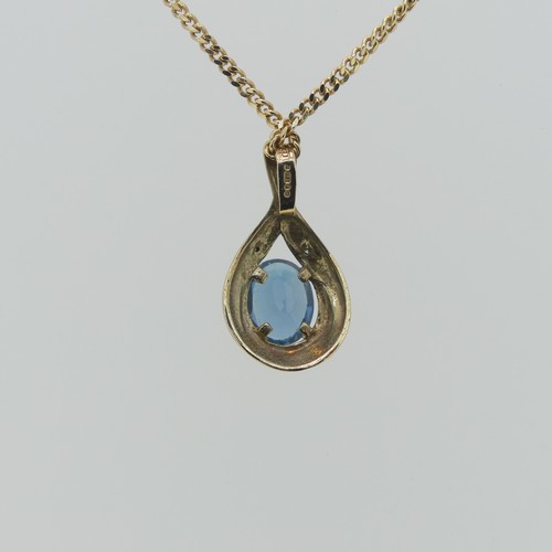 173 - A 9ct gold pear shaped Pendant, the centre with a facetted oval blue topaz, 8.9mm long, total length... 