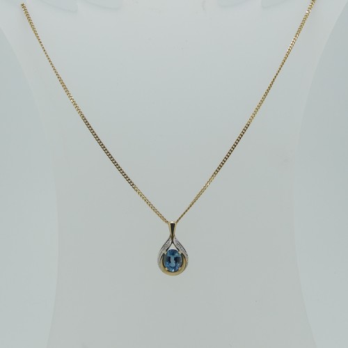 173 - A 9ct gold pear shaped Pendant, the centre with a facetted oval blue topaz, 8.9mm long, total length... 