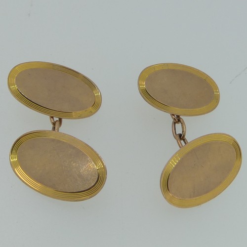 262 - A pair of 9ct rose gold oval Cufflinks, with reeded yellow gold border, chain between, 4.5g.... 