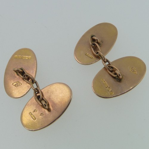 262 - A pair of 9ct rose gold oval Cufflinks, with reeded yellow gold border, chain between, 4.5g.... 