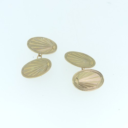 264 - A pair of 9ct yellow gold oval Cufflinks, each side engraved with starburst design, chain between, 4... 