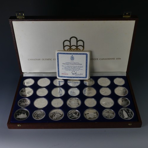 323 - A cased 1976 Canadian Olympics silver proof Coin Set, of twenty-eight coins, fourteen $10 coins and ... 