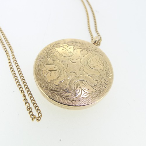 176 - A 9ct yellow gold circular hinged Locket, the front with foliate engraved decoration, 3.4cm diameter... 