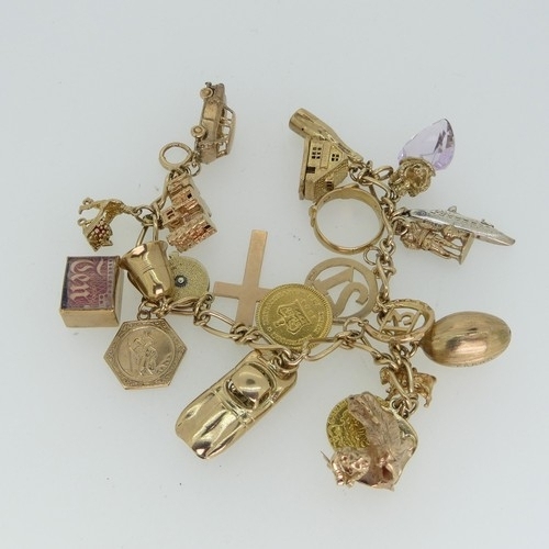 190 - A 9ct yellow gold Charm Bracelet, suspending a George III Third Guinea, dated 1804, a Quarter Guinea...