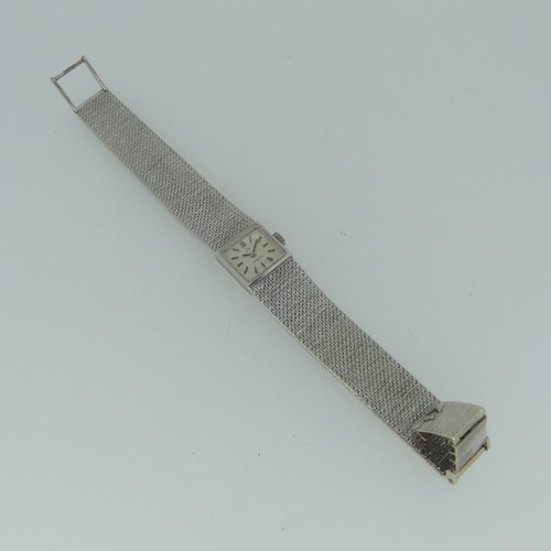 295 - A 9ct white gold lady's Omega bracelet Wristwatch, hallmarked London 1970, the square silvered dial ... 