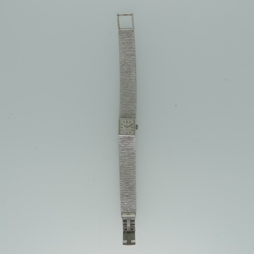 295 - A 9ct white gold lady's Omega bracelet Wristwatch, hallmarked London 1970, the square silvered dial ... 