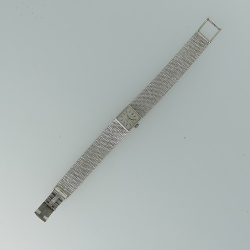 295 - A 9ct white gold lady's Omega bracelet Wristwatch, hallmarked London 1970, the square silvered dial ... 