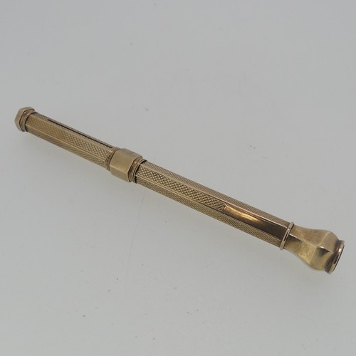 275 - A yellow metal Propelling Pencil, unmarked but tested as 9ct gold, with engine turned decoration, va... 