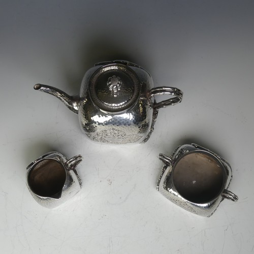 38 - An early 20thC Chinese export silver three piece Tea Set, of cube form with rounded shoulders, hamme... 