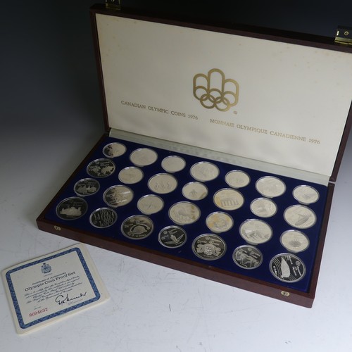 323 - A cased 1976 Canadian Olympics silver proof Coin Set, of twenty-eight coins, fourteen $10 coins and ... 